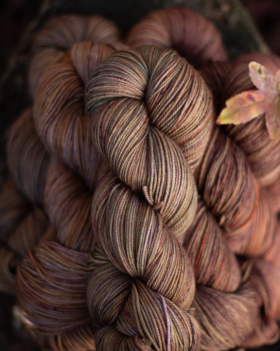 A small stack of autumnal brown hand-dyed yarn